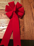 A red wreath bow